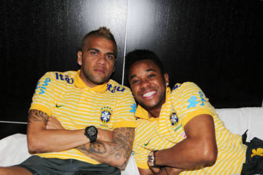 Daniel Alves e Robinho juntos sentados na mesma cama