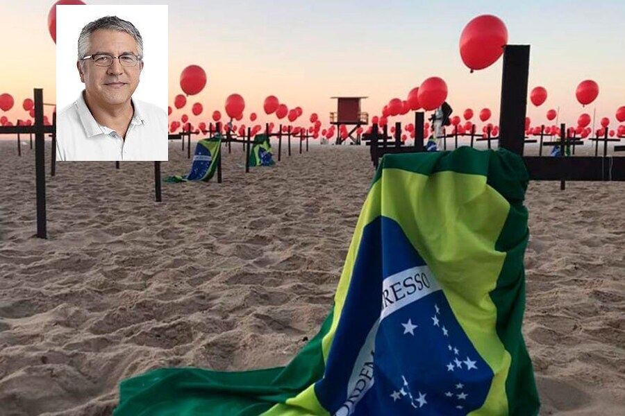 Montagem de foto do Deputado Alexandre Padilha sobre outra foto de inúmeras cruzes enterradas na areia da praia, com balões vermelhos e, no destaque, uma das cruzes porta a bandeira brasileira